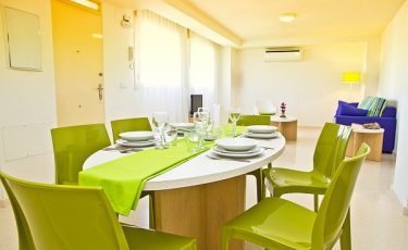 view of the living room and dining room in PV apartments in seville