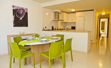 view of the kitchen and dining room in PV apartments in seville